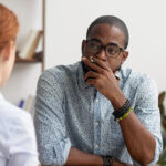 Frustrated manager listening to complaining employee